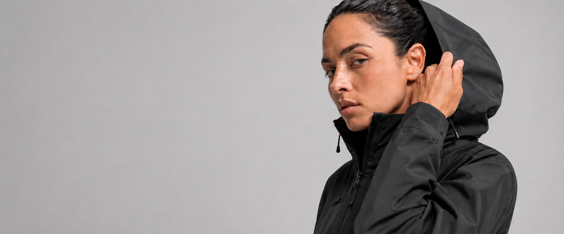 Woman wearing technical outdoor jacket European outerwear brand portfolio